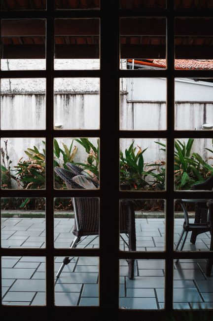Backyard cottage beside a patio, with windows and outdoor space visible.